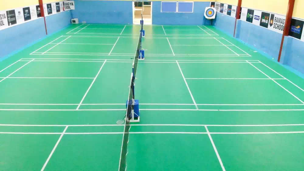 Soccer team celebrating a goal on a sunny day on lush green field