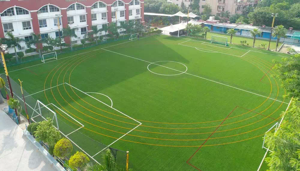 Modern sports facility with athletes training on indoor basketball court and weightlifting area