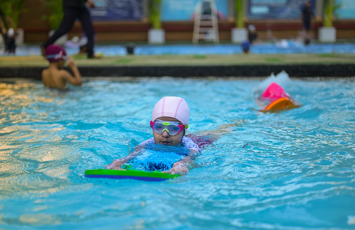 Swimmer diving into an Olympic-sized pool with perfect form