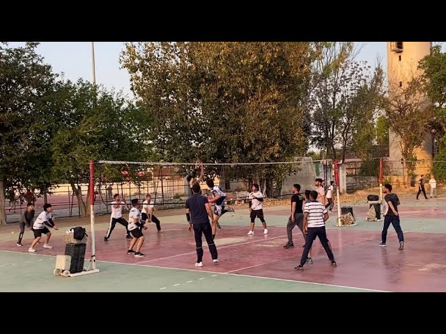 Volleyball team in action during a match with dramatic lighting